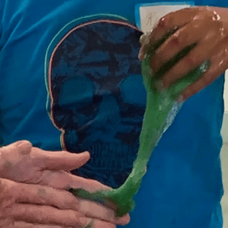 Parent and young person hands in green slime