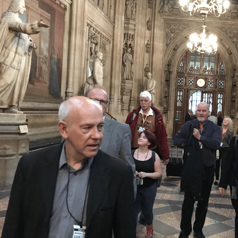 Man walking ahead of others in parliament
