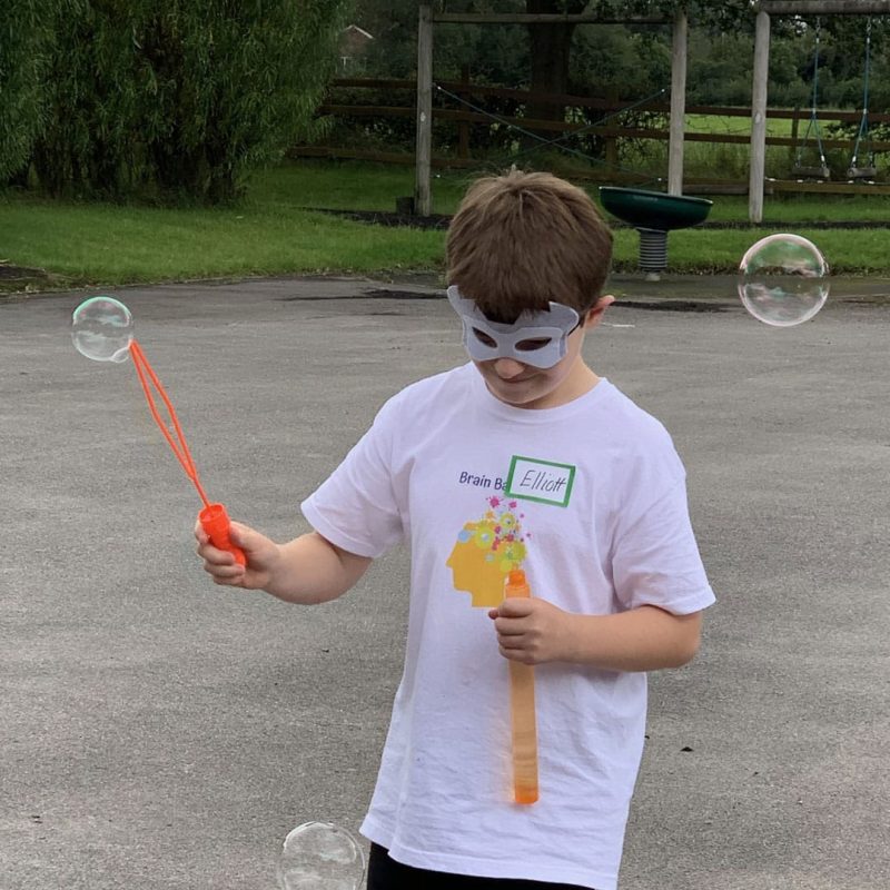 boy in mask playing with bubbles